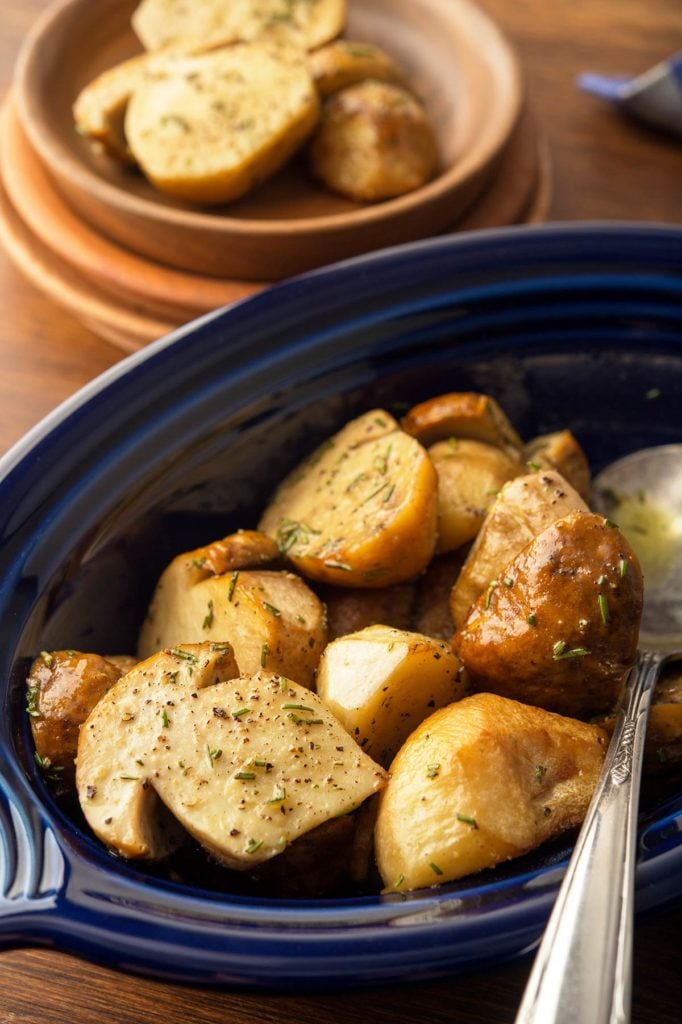 Closeup of roasted mushrooms with garlic in a serving platter. 