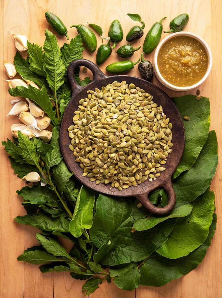 Ingredients for making pipian verde on a cutting board. 