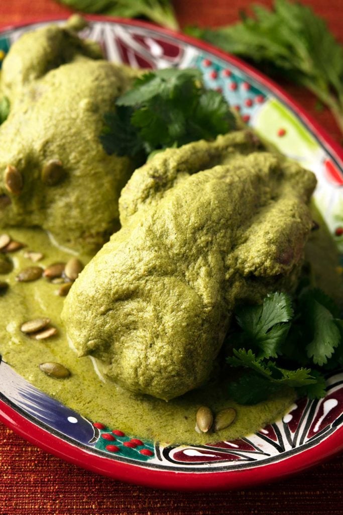 Closeup of a platter of pipian verde with partridges. 