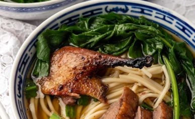 Two bowls of duck noodle soup.