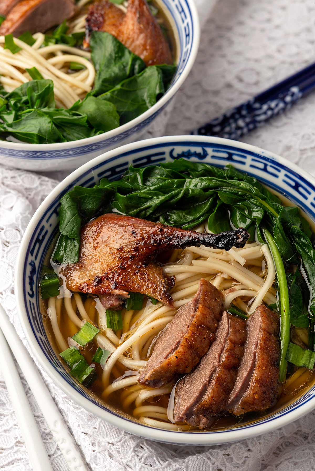 Two bowls of duck noodle soup.