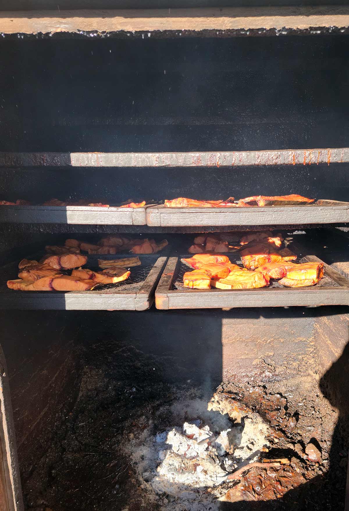 Fish smoking over manzanita coals in Ensenada, Baja. 