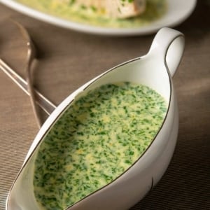 A gravy boat full of British parsley sauce.