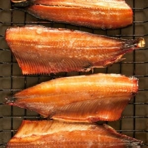 Closeup of fillets of smoked shad on a rack.