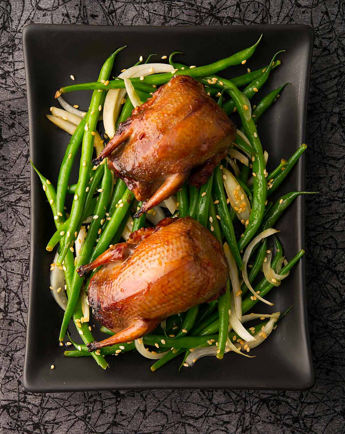 Dove teriyaki on a platter with a Japanese salad. 