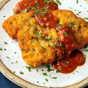 Closeup of turkey schnitzel on a plate with Southern tomato gravy.