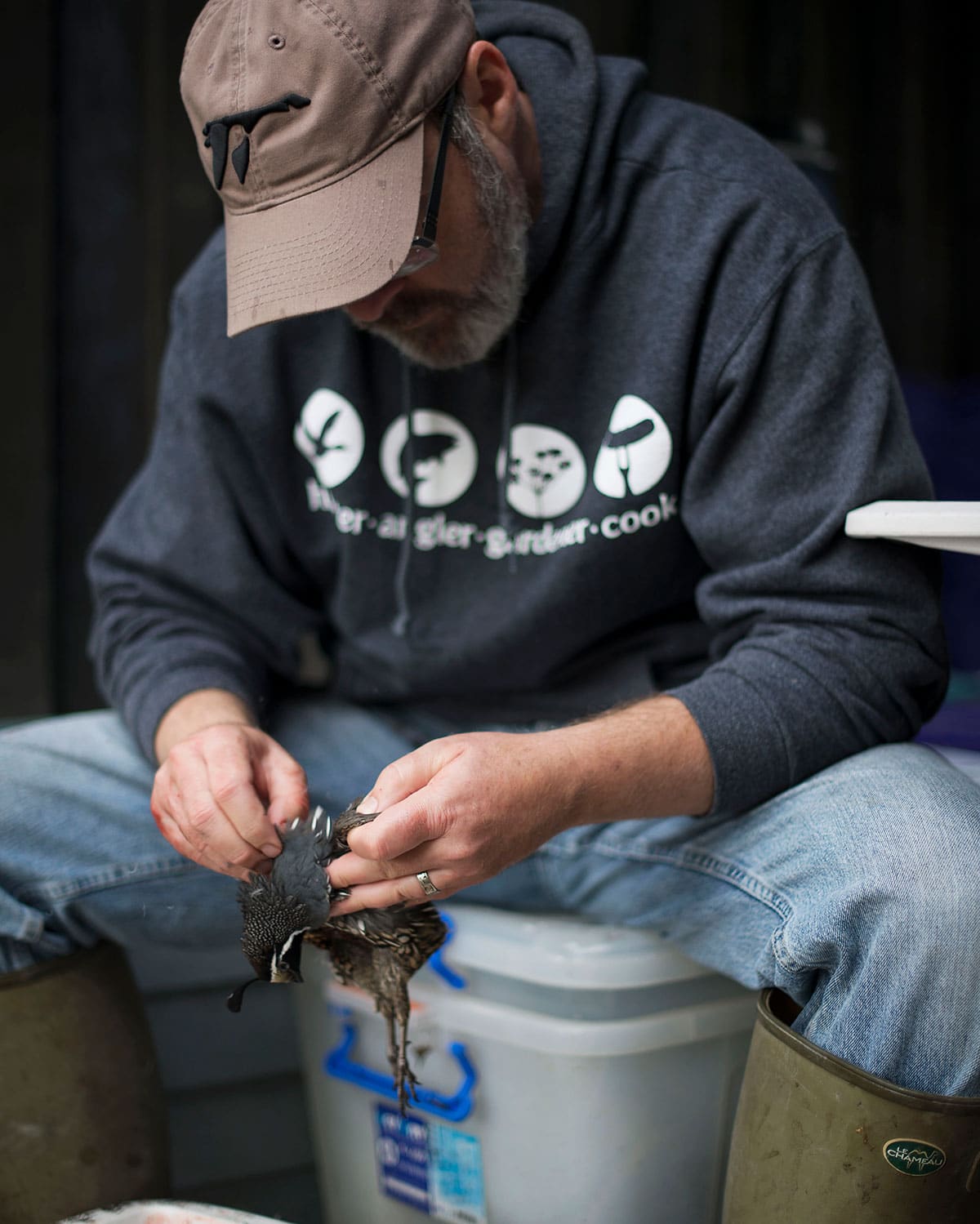 Hank Shaw plucking quail in New Zealand. 