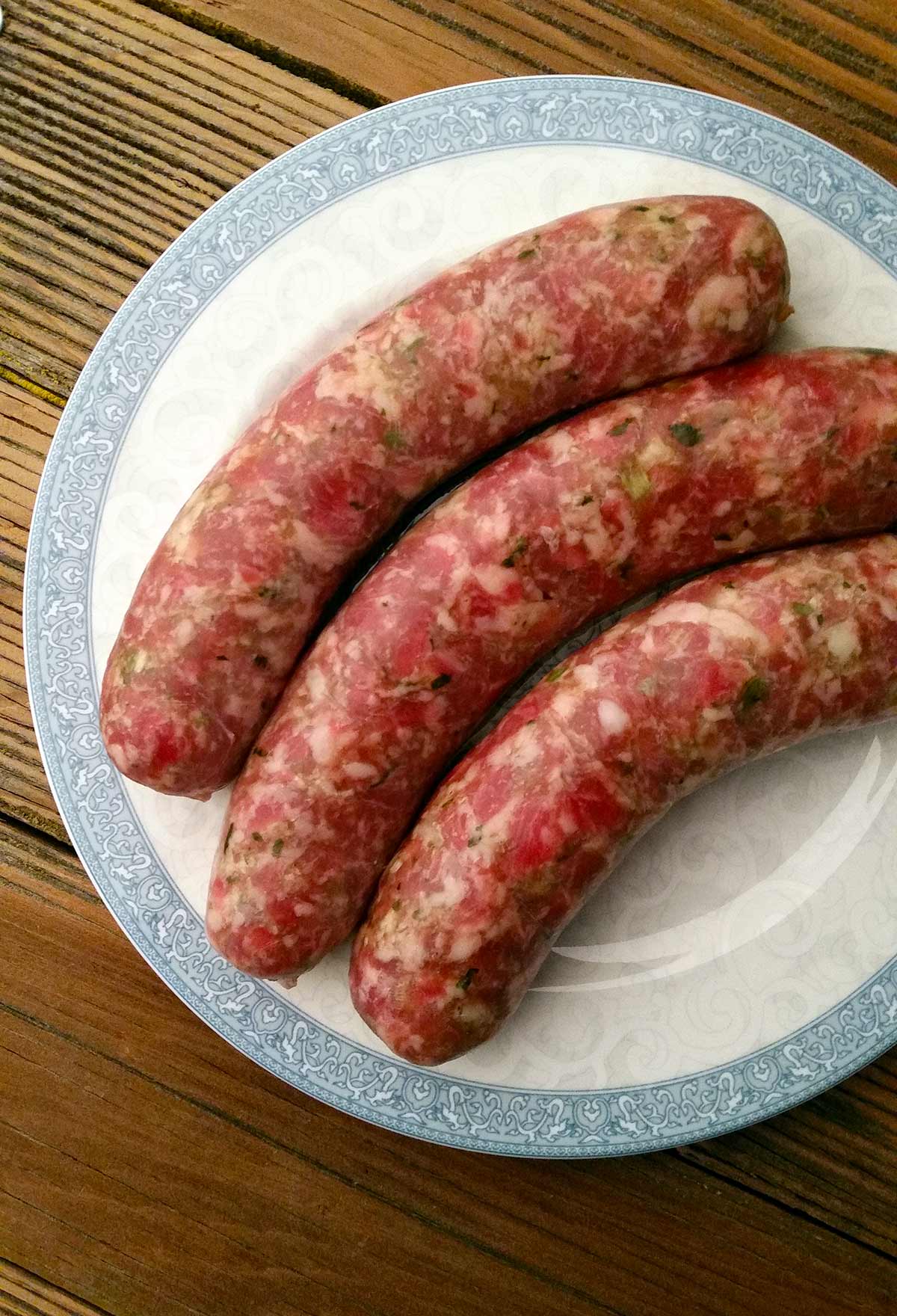 Three links of Hmong sausage on a plate. 