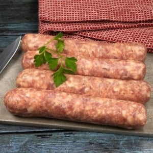 Four links of Toulouse sausage on a cutting board.