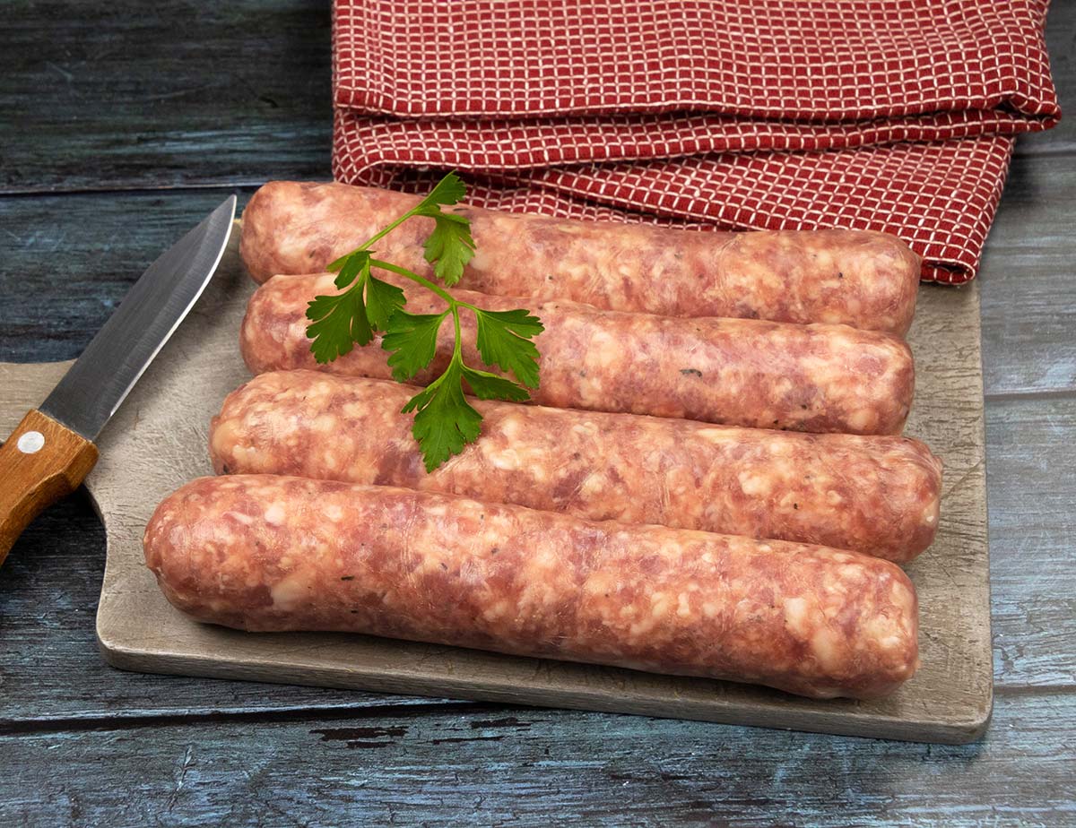 Four links of Toulouse sausage on a cutting board. 