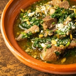 pork with amaranth greens in a bowl.