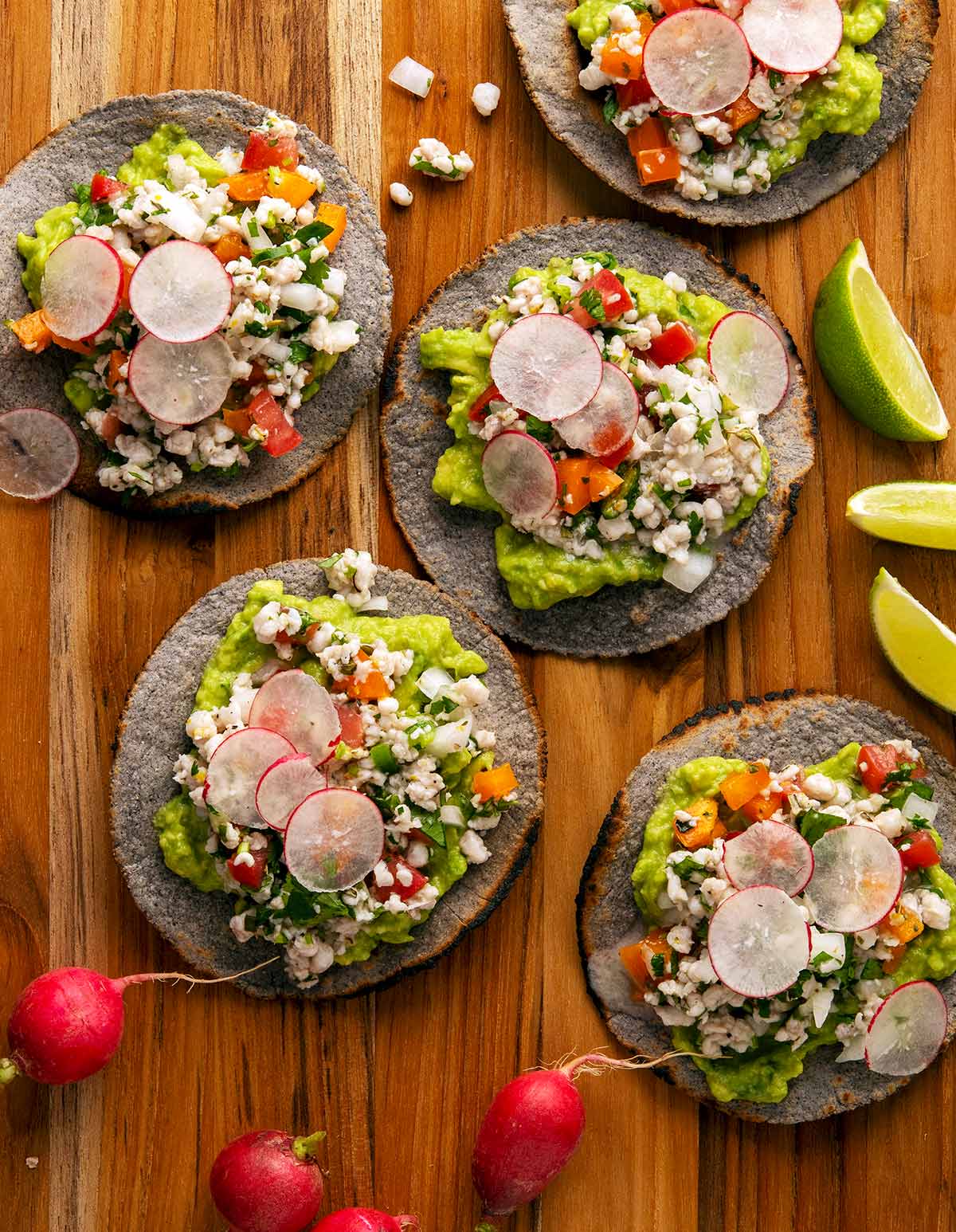 Several ceviche tostadas on a platter with mahi mahi ceviche. 