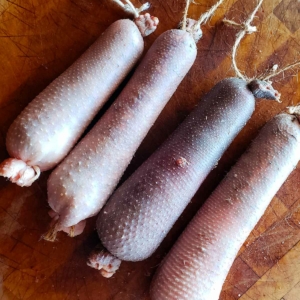Four goose neck sausages, cou farci. uncooked and ready for roasting.