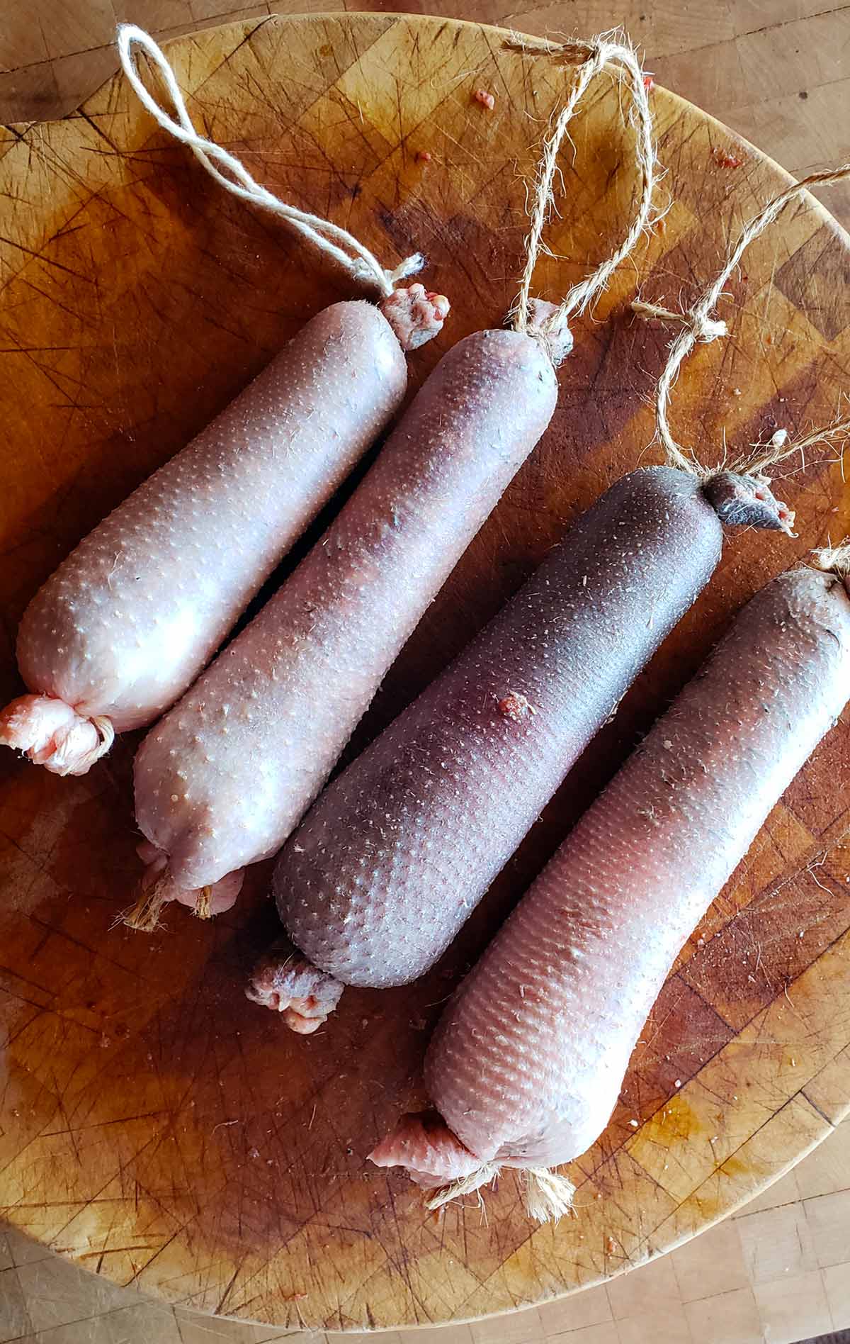 Four goose neck sausages, cou farci. uncooked and ready for roasting. 