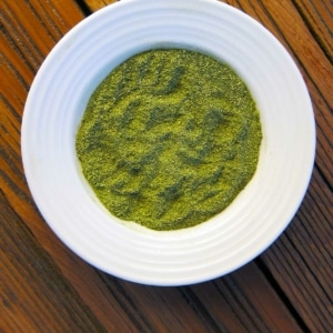 A bowl of green salt, made at home.