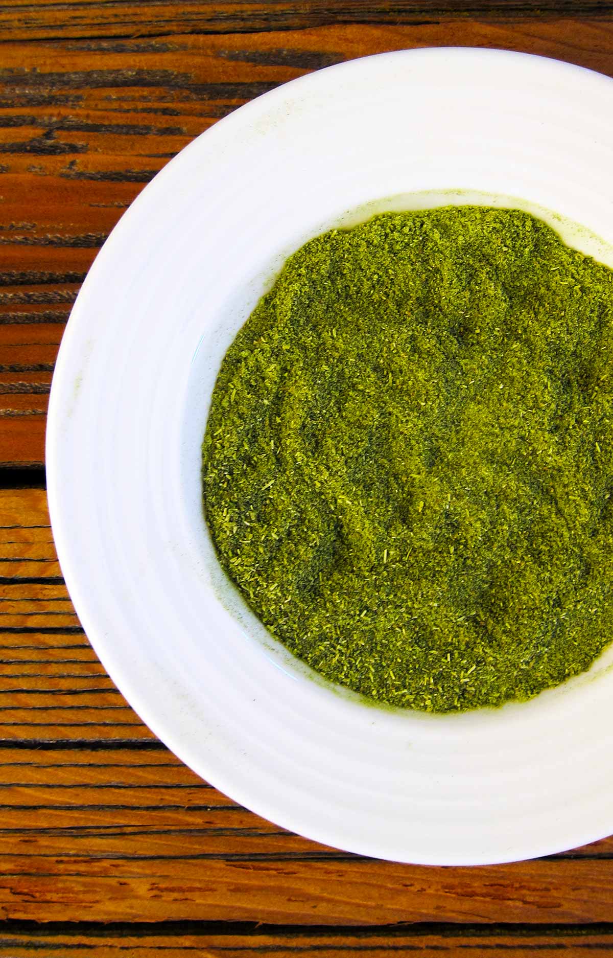 Closeup of green salt in a bowl. 