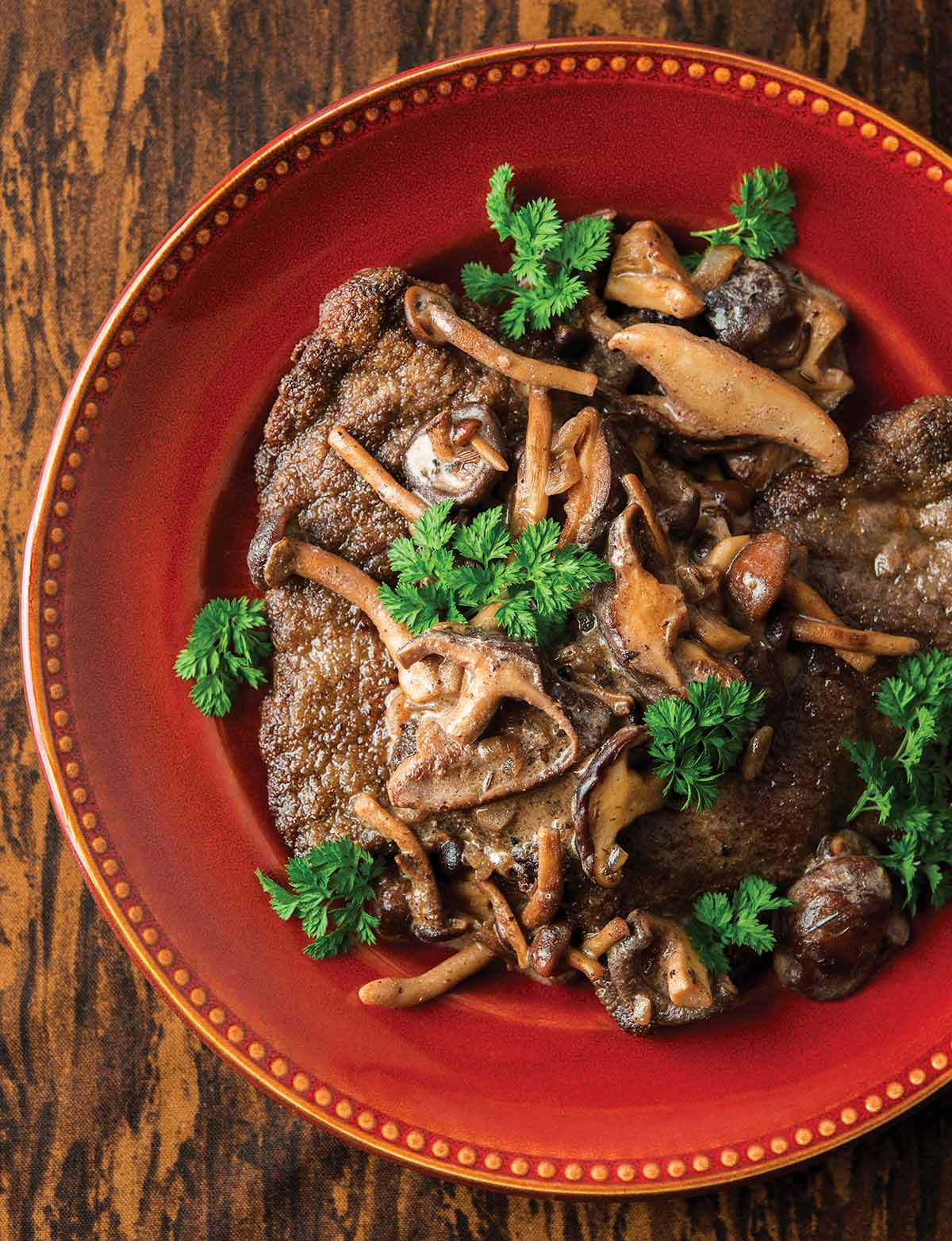 German jagerschnitzel served with a mushroom sauce, on a rustic plate. 