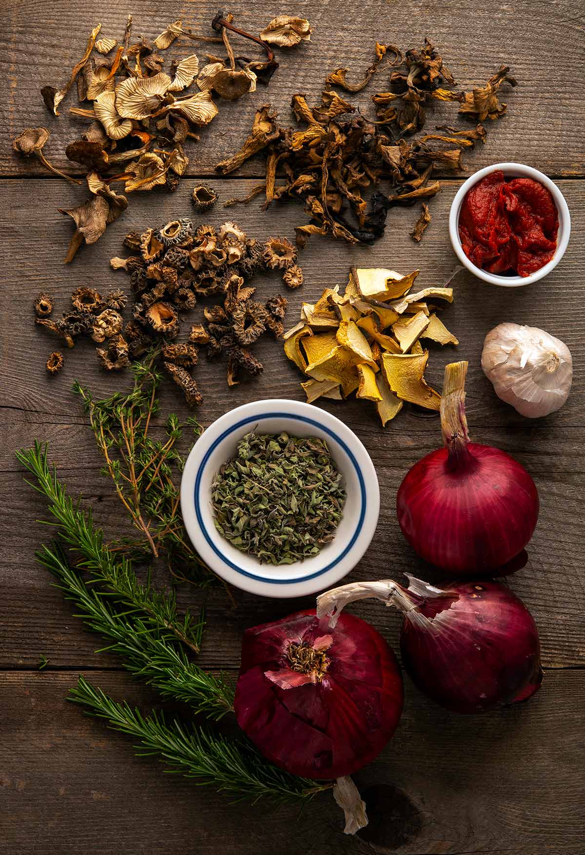 Ingredients for mushroom ragu: onions, dried mushrooms, herbs and tomato. 