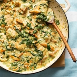 Pheasant with mushrooms, cream and greens in a pot.