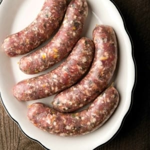 Five links of pheasant sausage on a platter.