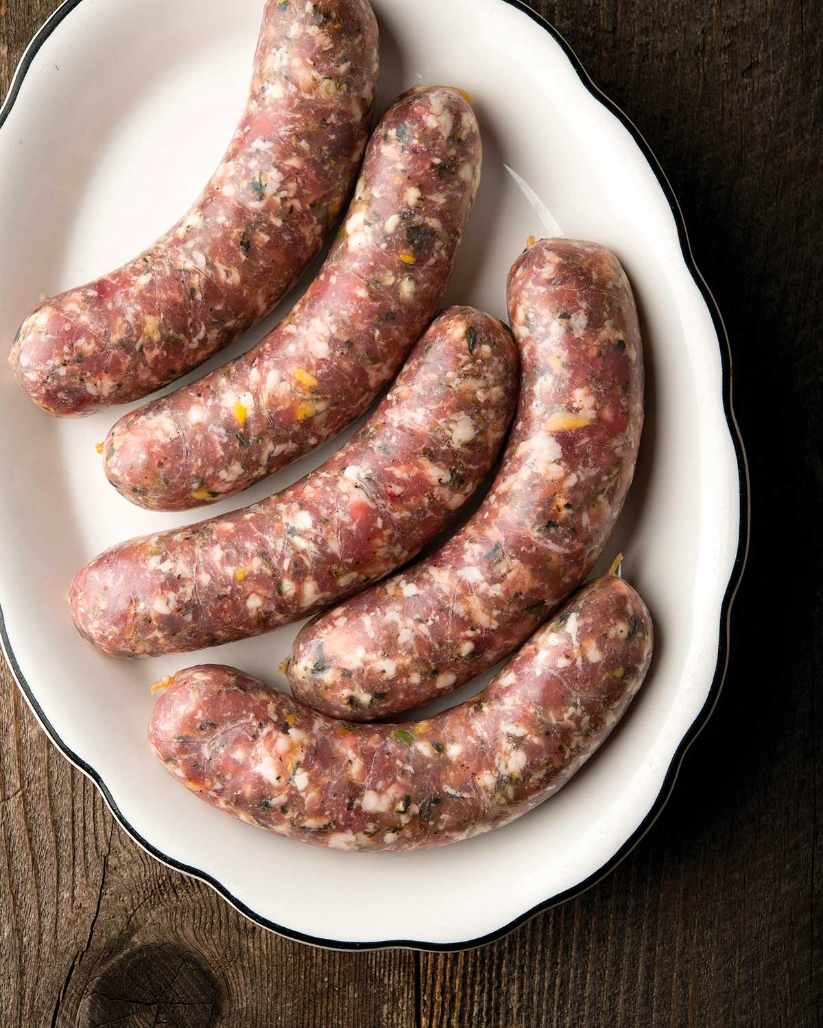 Five links of pheasant sausage on a platter.
