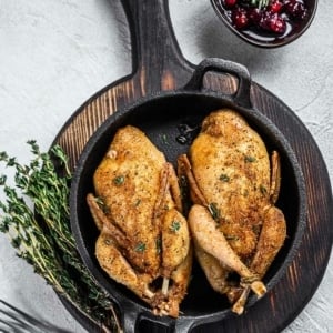 The finished chukar recipe: two roasted chukars in a cast iron pan.