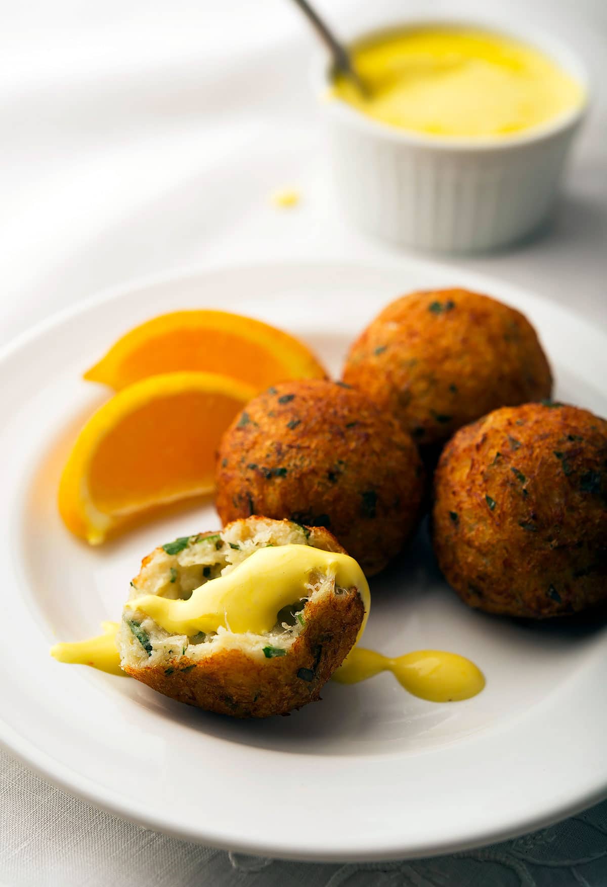 Saffron aioli served with salt cod fritters on a plate. 