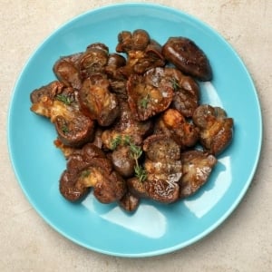 A plate of seared deer kidney with herbs.