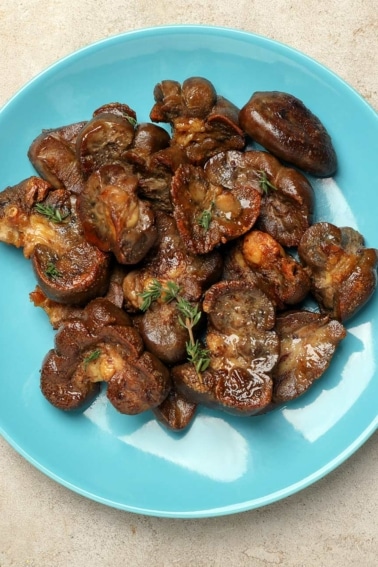 A plate of seared deer kidney with herbs.