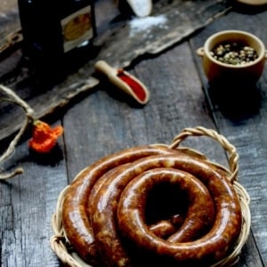 A coil of venison sausage on a table.