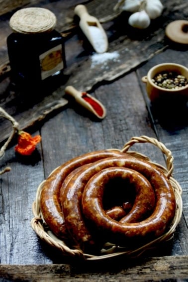 A coil of venison sausage on a table.