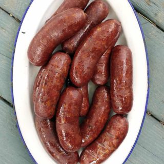 A platter of wild boar sausage, cooked and ready to eat.