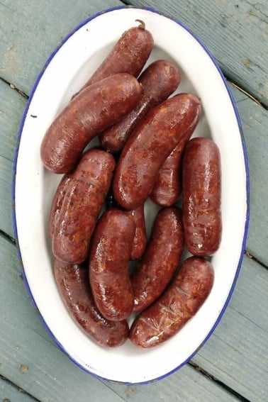A platter of wild boar sausage, cooked and ready to eat.