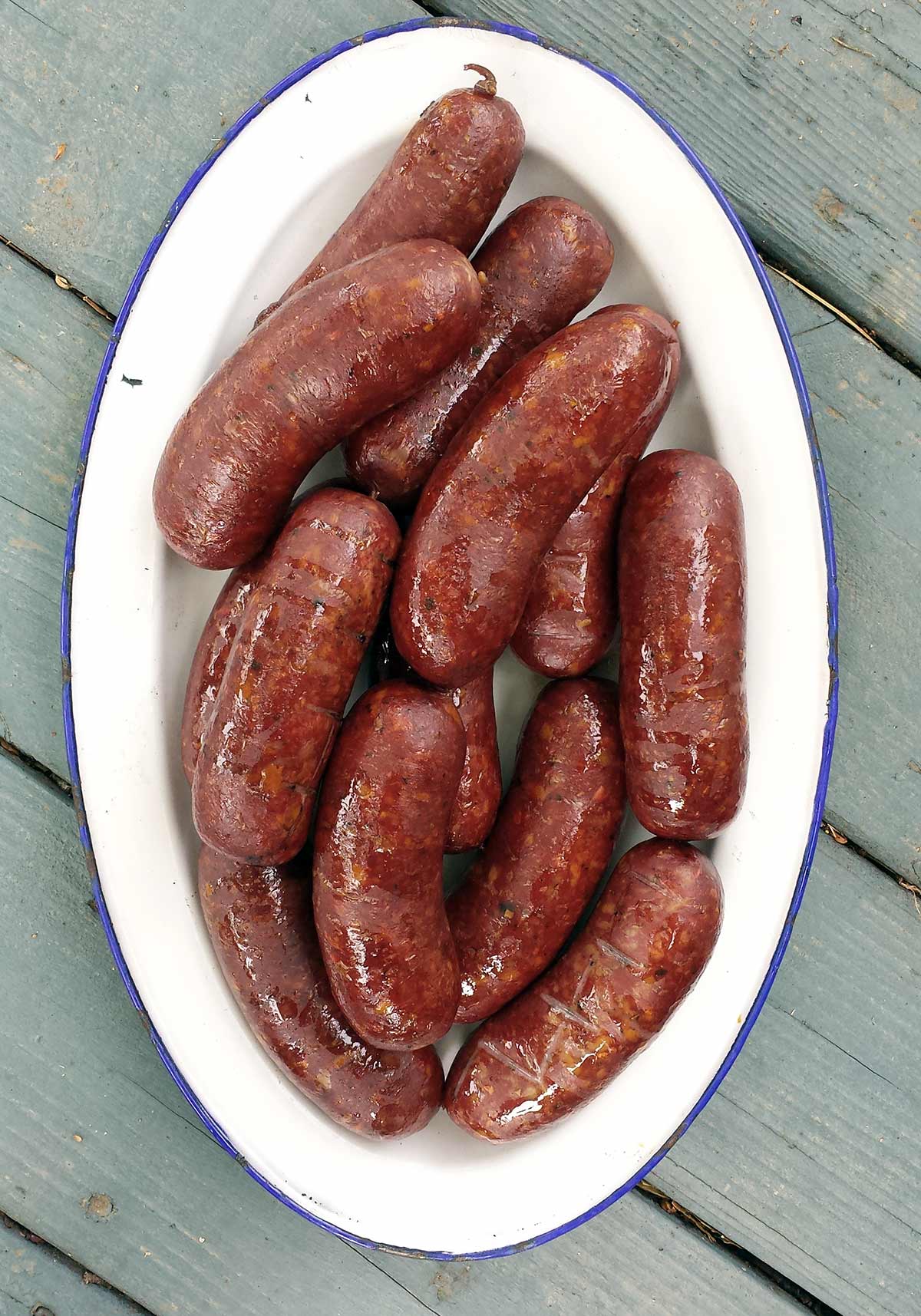 A platter of wild boar sausage, cooked and ready to eat. 