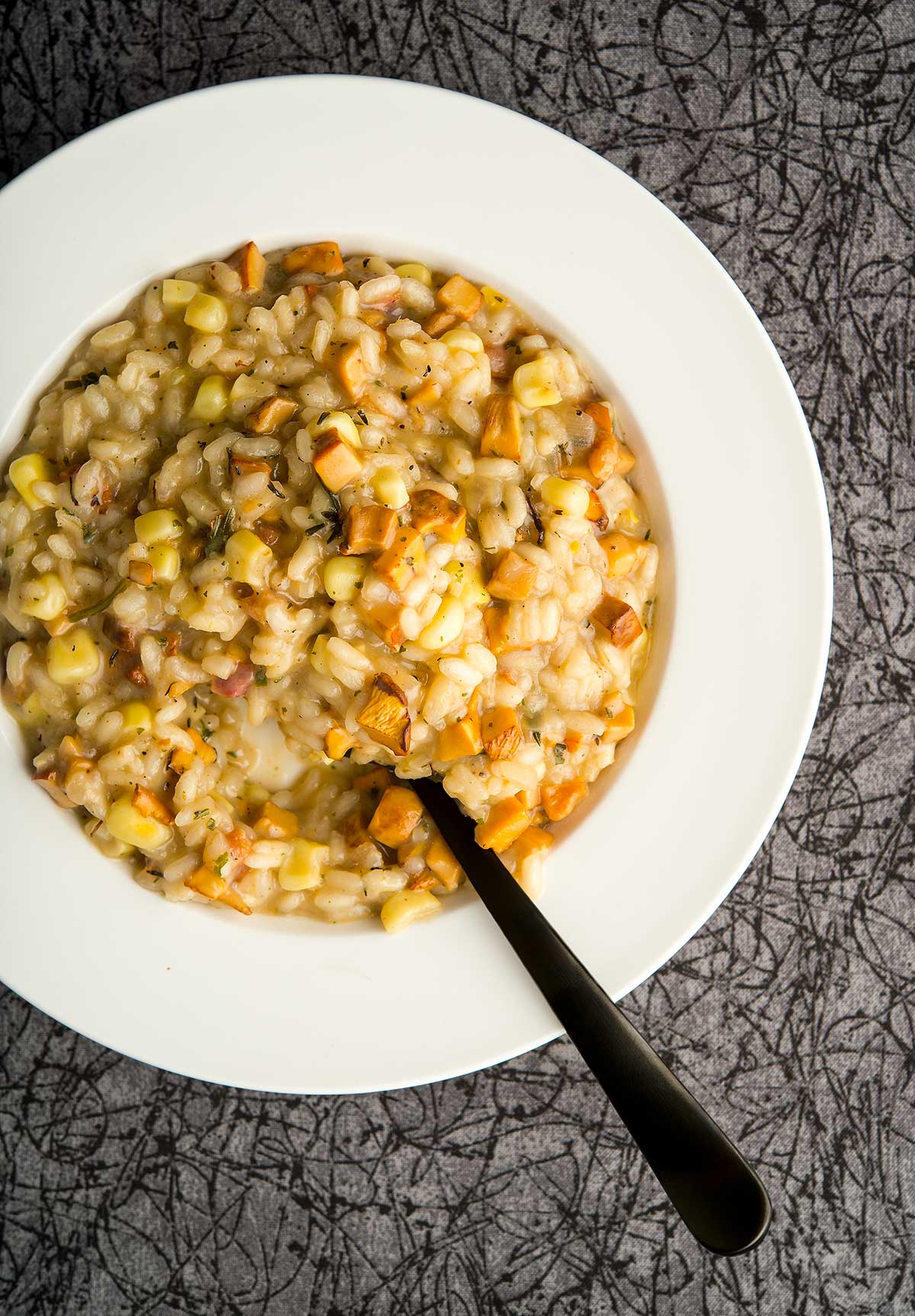 A bowl of chanterelle risotto with fresh corn. 