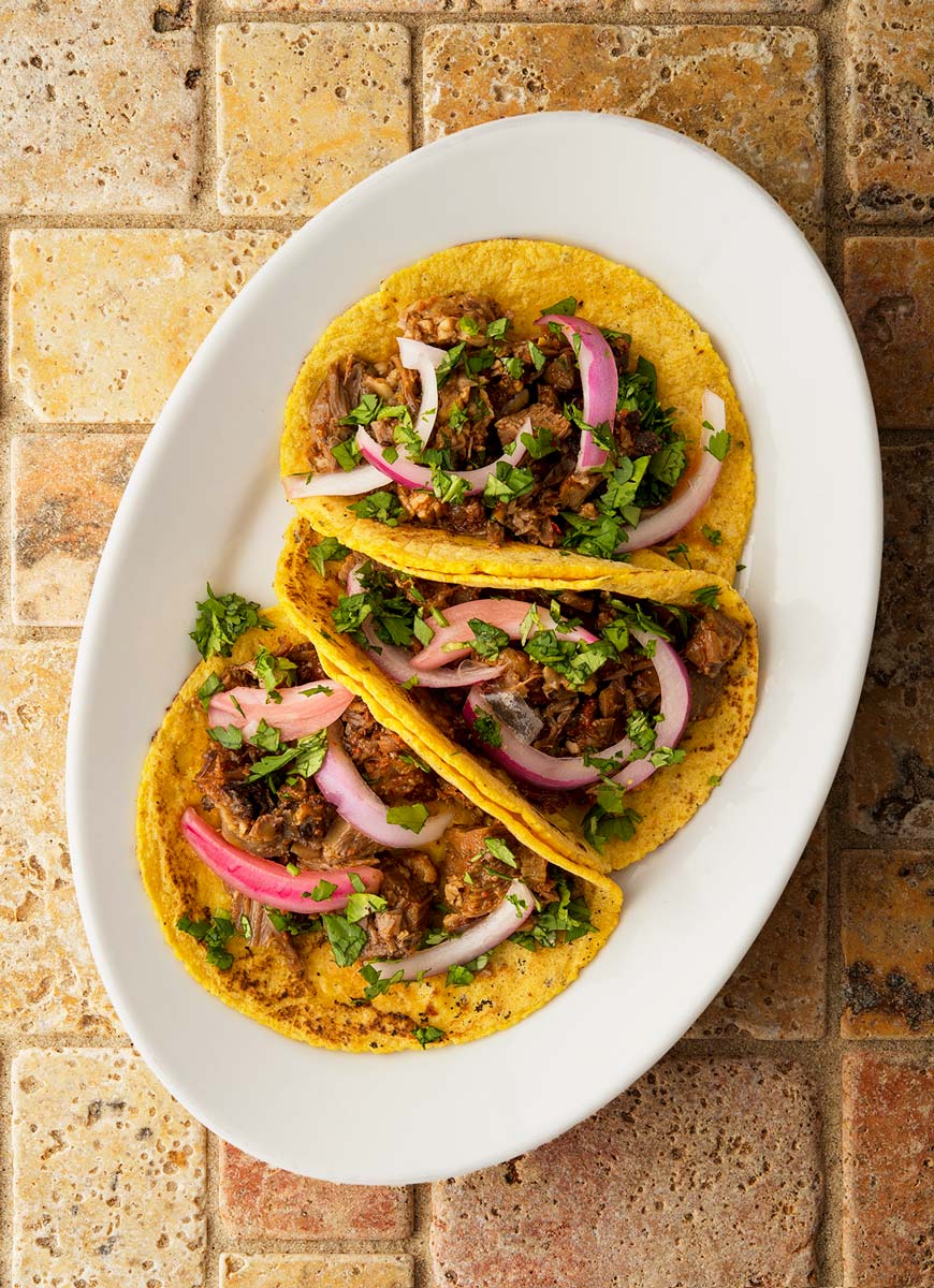 three tacos de cabeza on a plate