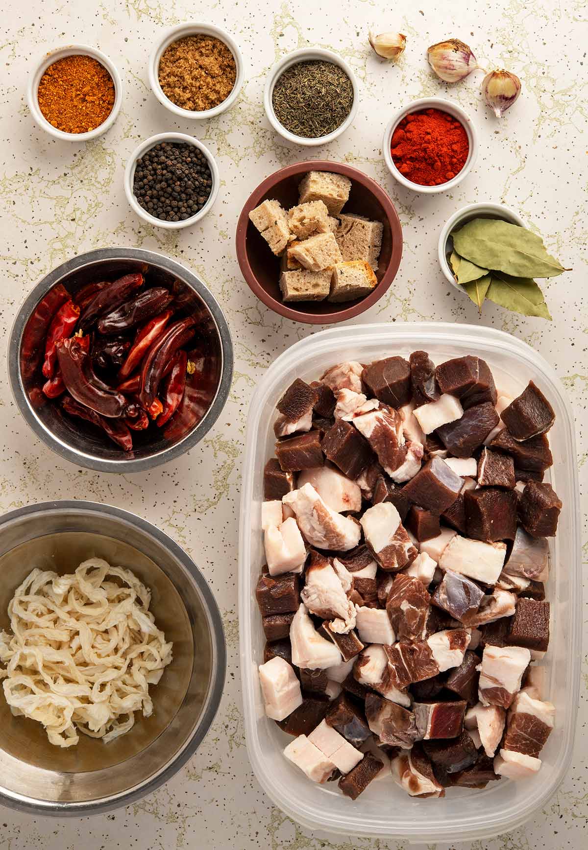 Ingredients for making homemade sausage: casings, meat and fat, seasonings and some bread cubes.