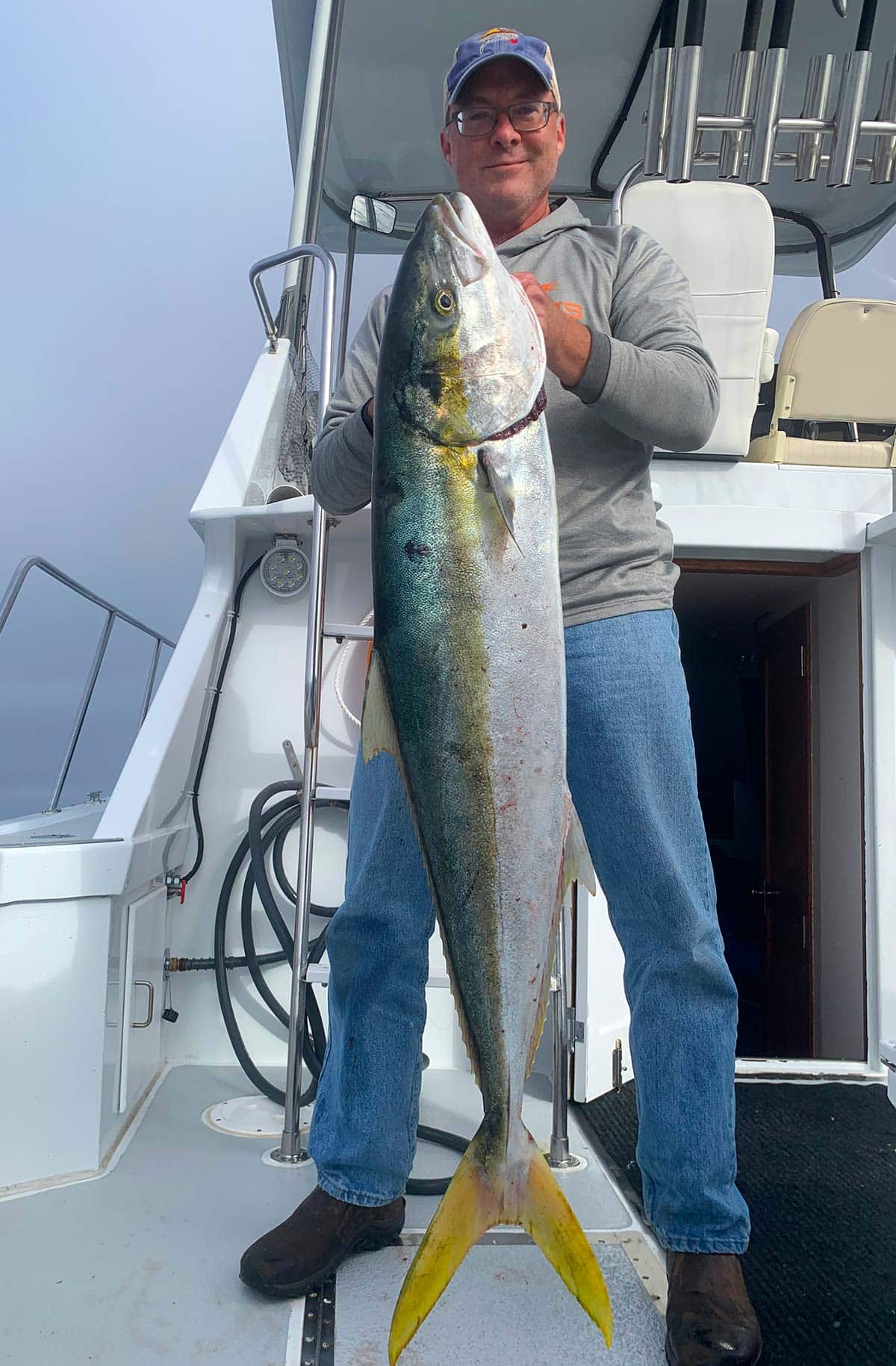 Hank Shaw holding a yellowtail fish. 