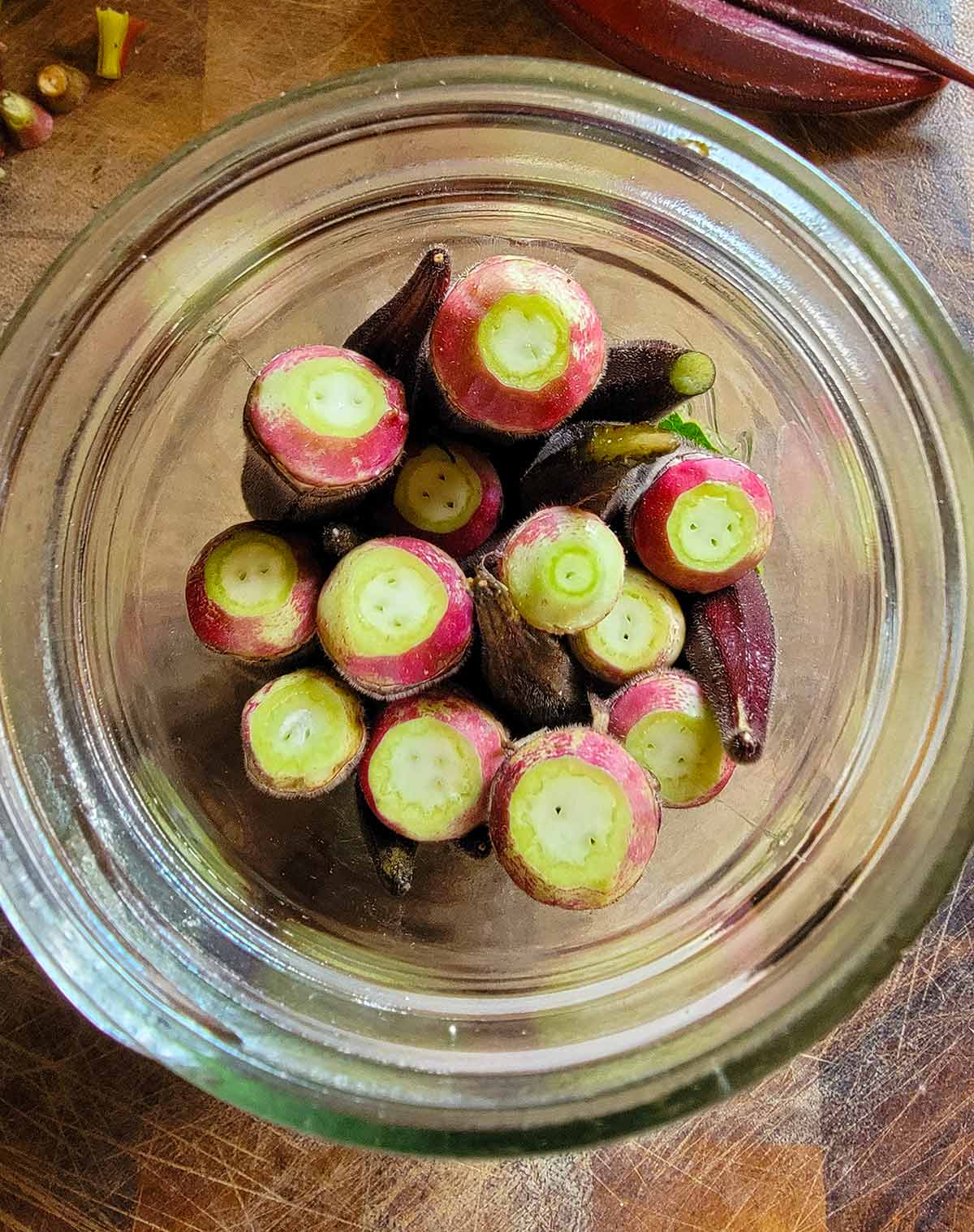 Okra packed into a pickle jar. 