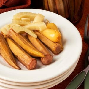 Spicy pickled okra on a plate with other pickles.