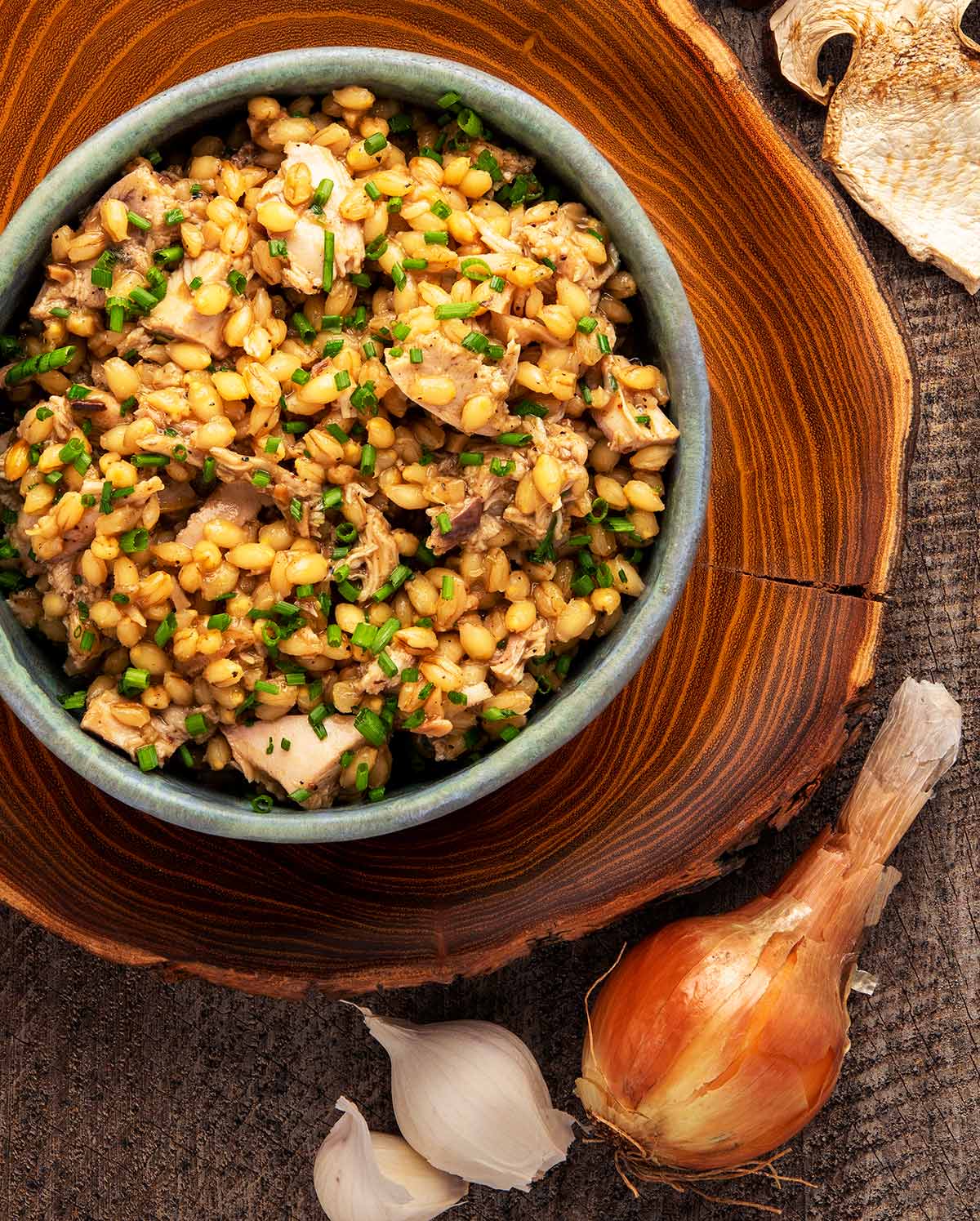 A bowl of barley risotto with mushrooms, onions and garlic. 