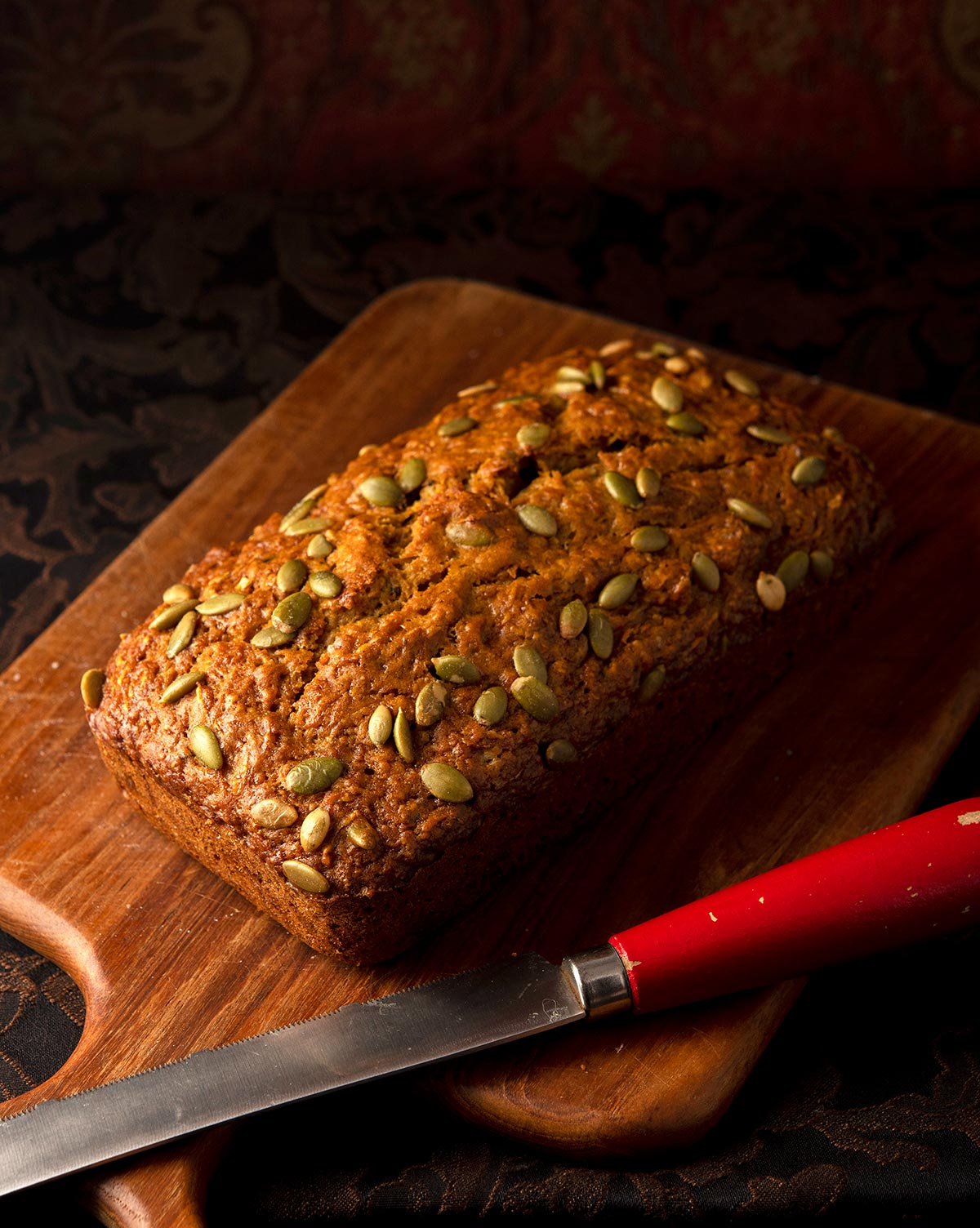 A loaf of butternut squash bread on a cutting board. 