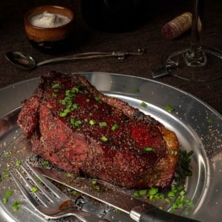 A bison steak on a plate.