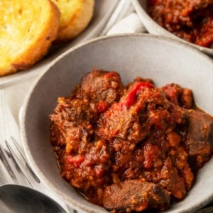 A bowl of caldereta made with a venison neck roast.