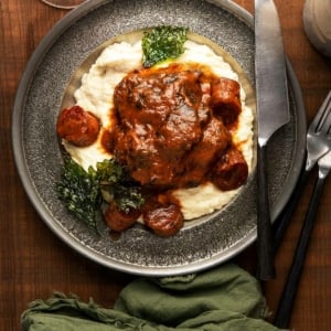 Red wine braised beef cheeks over mashed potatoes.