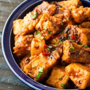 Close up of a bowl of stir fried fish.