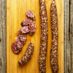 Spanish fuet sausages on a cutting board.