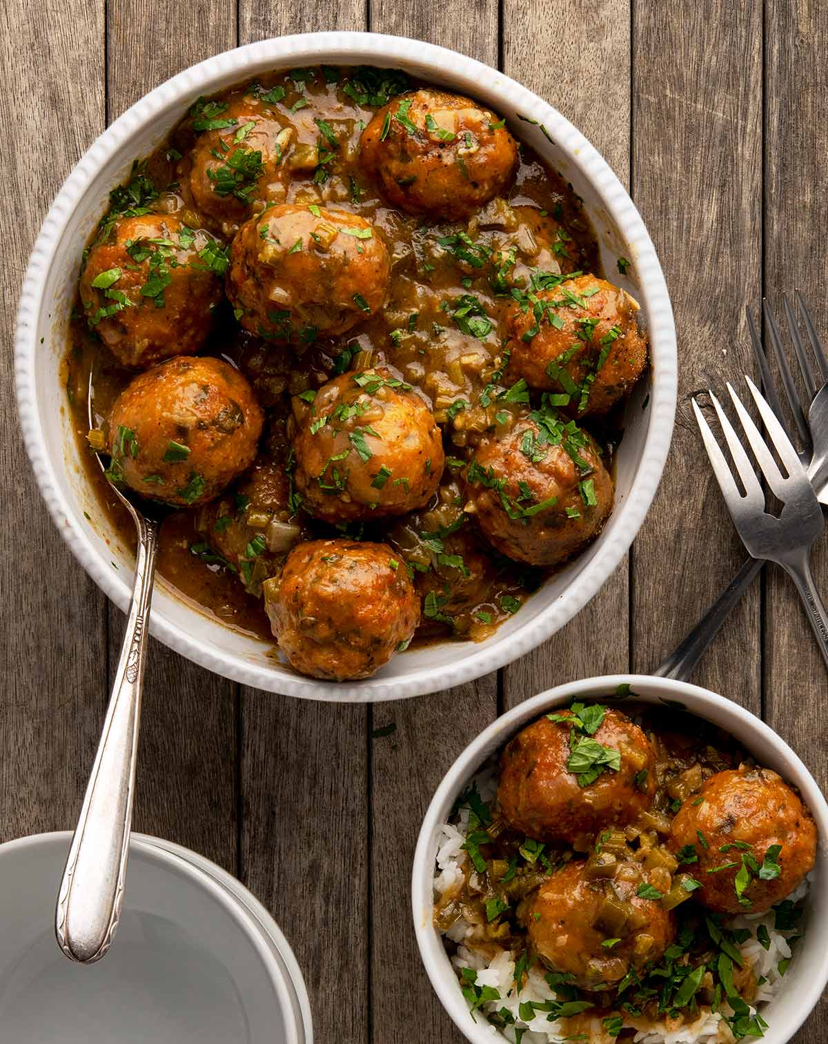 A serving bowl of Louisiana gar balls with a smaller bowl alongside. 