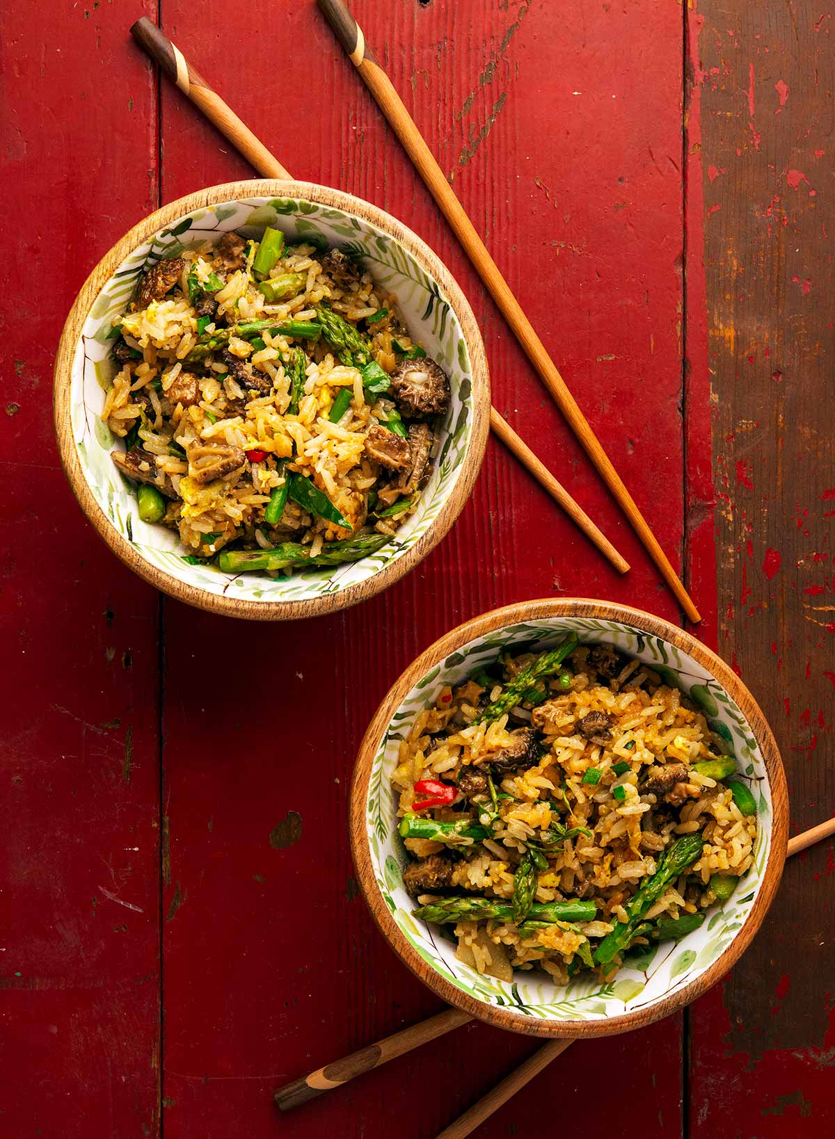 Two bowls of mushroom fried rice with asparagus. 