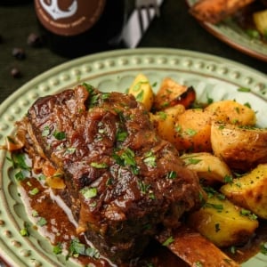 Close up of beer braised short ribs on a plate with root vegetables.